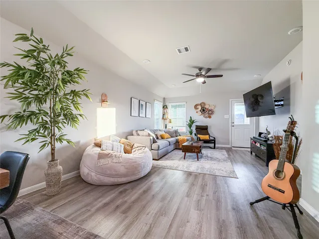 a living room with furniture or couch and a potted plant