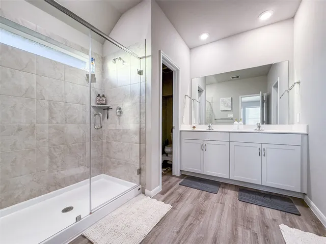 a toilet sitting in a bathroom next to a wooden wall