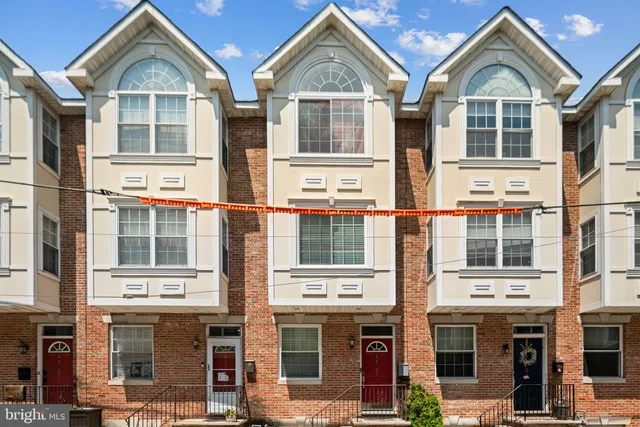 a front view of a residential apartment building with a yard