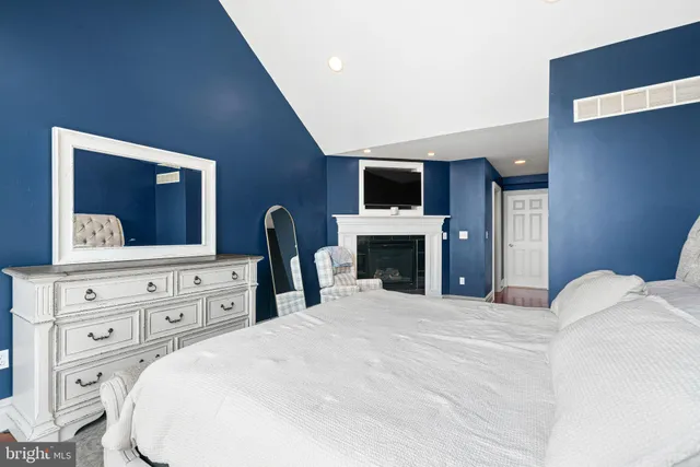 a bedroom with a large bed and a television