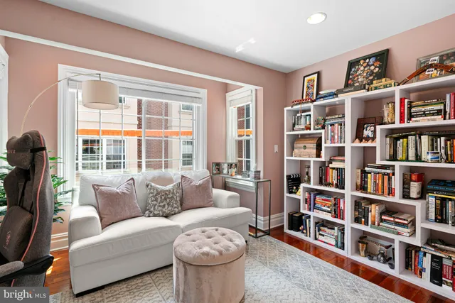 a living room with furniture and a book shelf