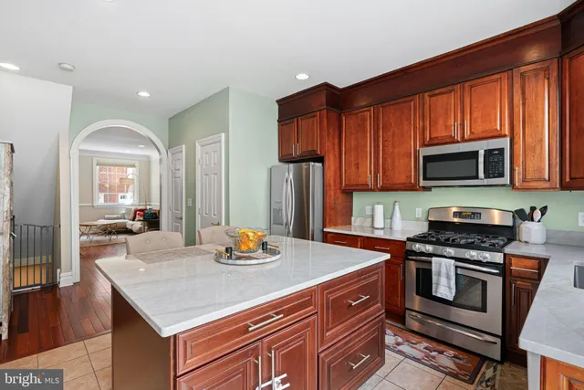 a kitchen with stainless steel appliances granite countertop a stove a sink dishwasher a microwave oven with granite countertops and cabinets