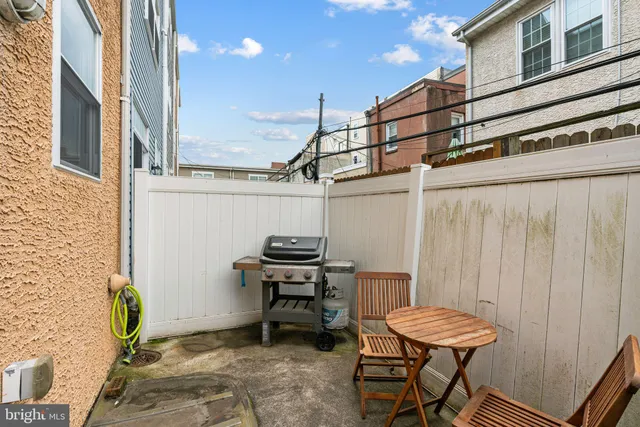 a patio with table and chairs