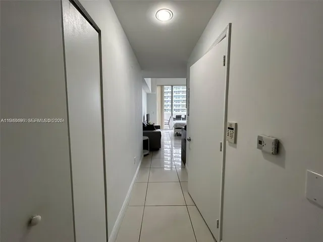 a view of a hallway view with wooden floor and staircase