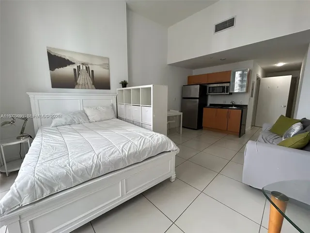 a bedroom with a bed and a couch