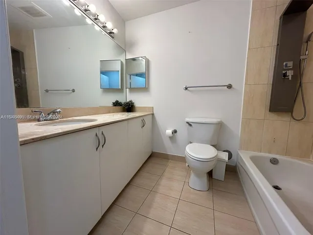 a bathroom with a toilet sink shower and mirror