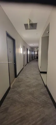 a view of a hallway with staircase