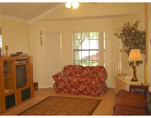 a living room with a bed furniture and a window