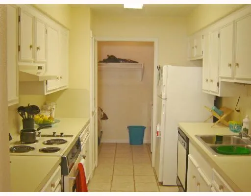 a kitchen with a sink and a refrigerator