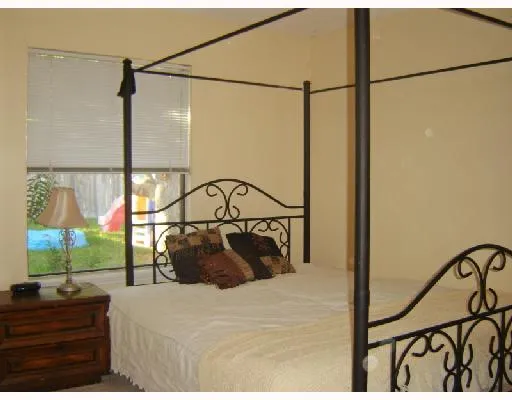 a bedroom with a bed a dresser and a window