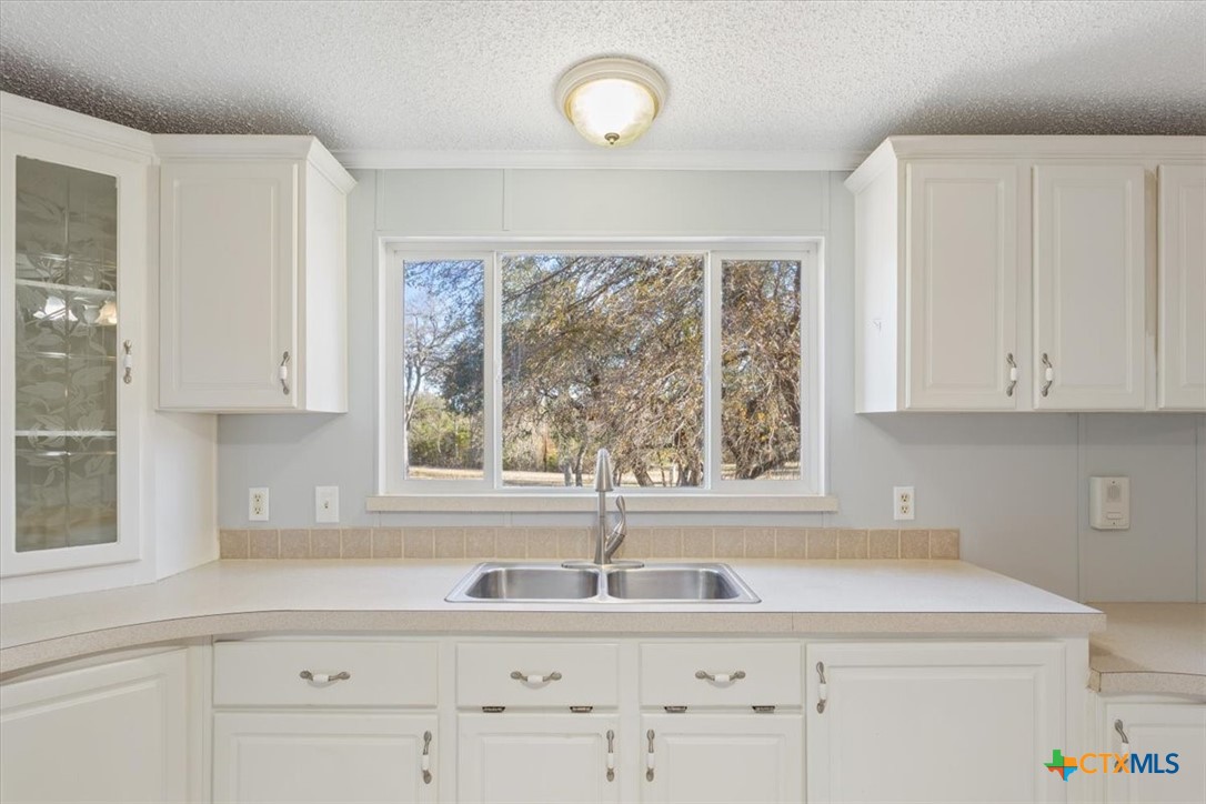 706 County Road 3376 Kempner, TX 76539 - Photo 13 of 31 a kitchen with a sink cabinets and a large window