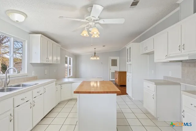 a kitchen with a sink cabinets and window