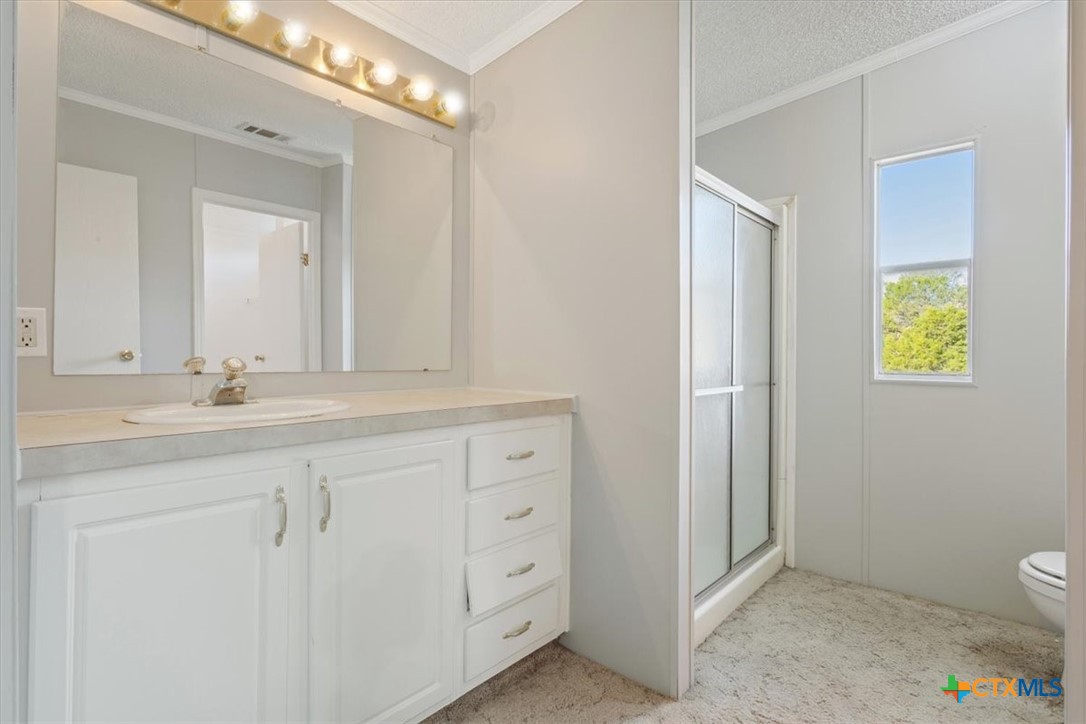 706 County Road 3376 Kempner, TX 76539 - Photo 20 of 31 a bathroom with a sink a toilet and a mirror