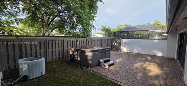 a view of backyard with wooden fence and trees