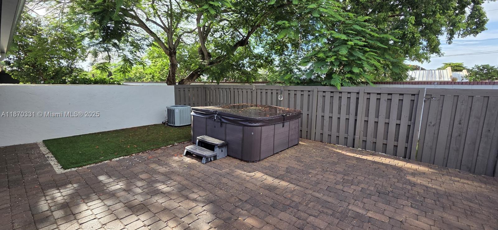 11527 Southwest 84th Lane Miami, FL 33173 - Photo 6 of 17 a view of backyard with wooden fence and trees