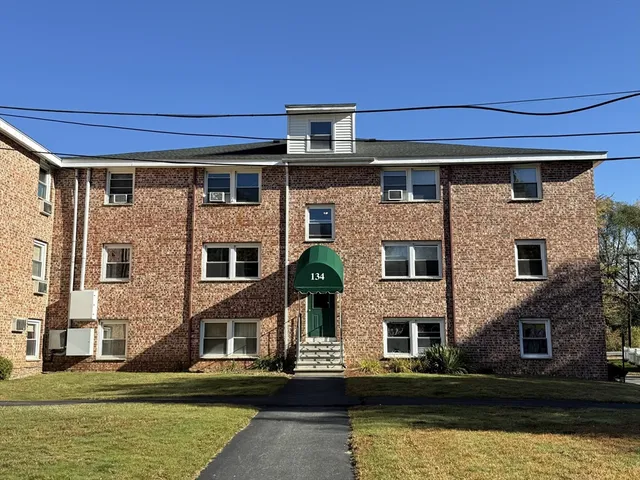 a front view of a house with a large pool