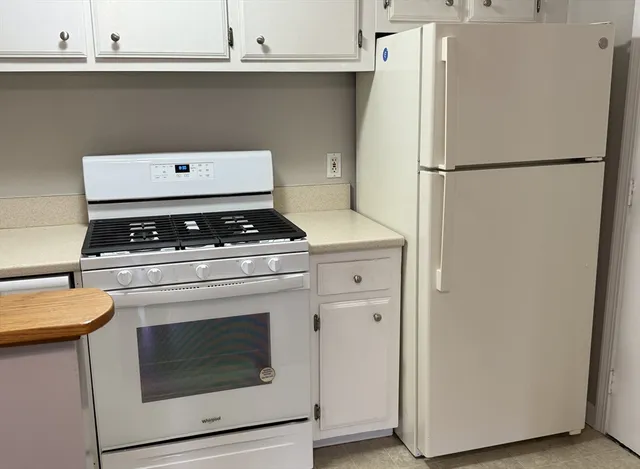 a stove top oven sitting inside of a kitchen