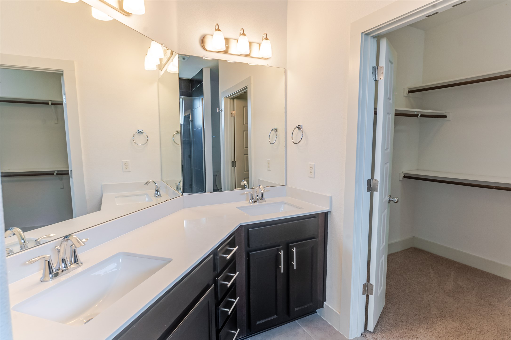 1400 Homespun Road Austin, TX 78745 - Photo 17 of 30 Clean lines and a spacious layout define this modern bathroom with an adjacent closet.