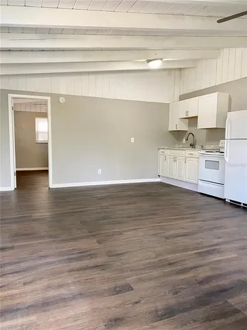 a view of a kitchen with stainless steel appliances cabinets and wooden floor