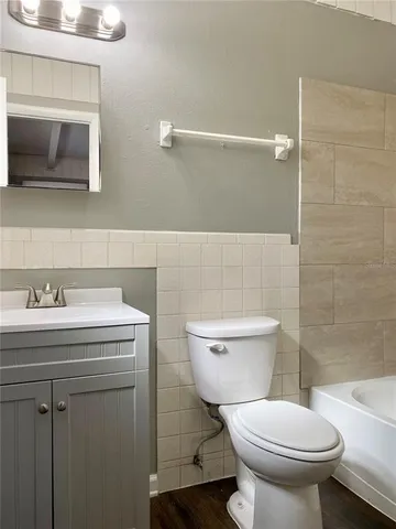 a bathroom with a sink a toilet and a mirror