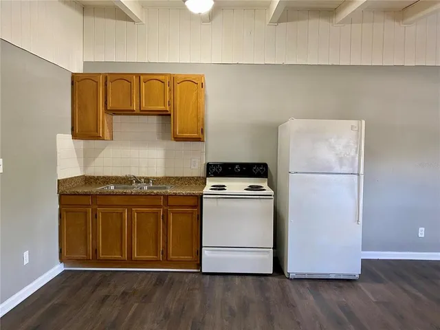a kitchen with a stove and a refrigerator