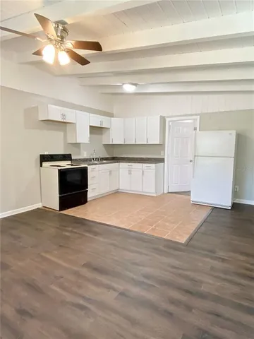 a view of a kitchen with a dishwasher cabinets and wooden floor