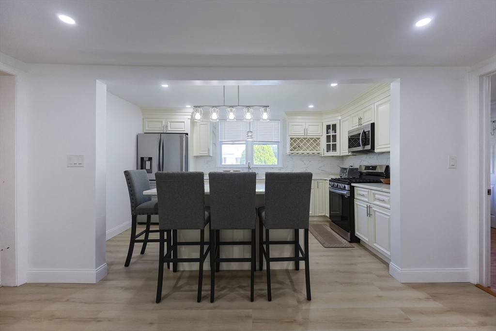 1245 North High Street Fall River, MA 02720 - Photo 12 of 28 a kitchen with a dining table chairs and refrigerator