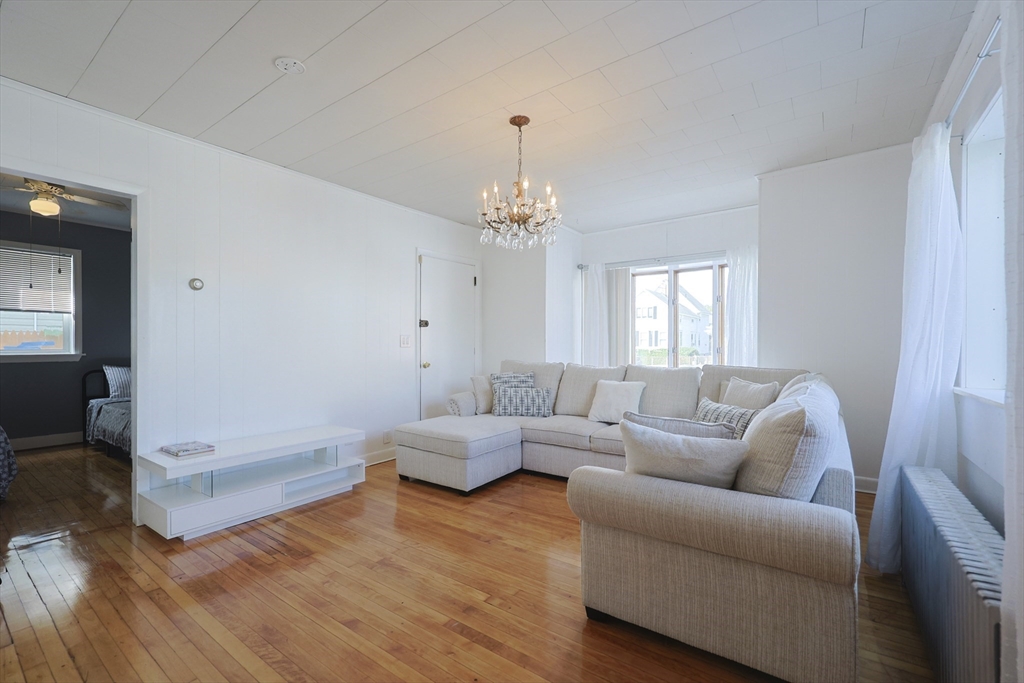 1245 North High Street Fall River, MA 02720 - Photo 14 of 28 a living room with furniture and a chandelier