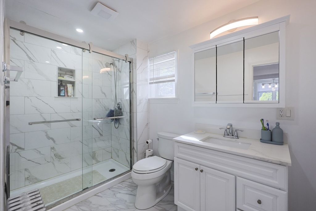 1245 North High Street Fall River, MA 02720 - Photo 16 of 28 a bathroom with a shower sink vanity mirror and toilet