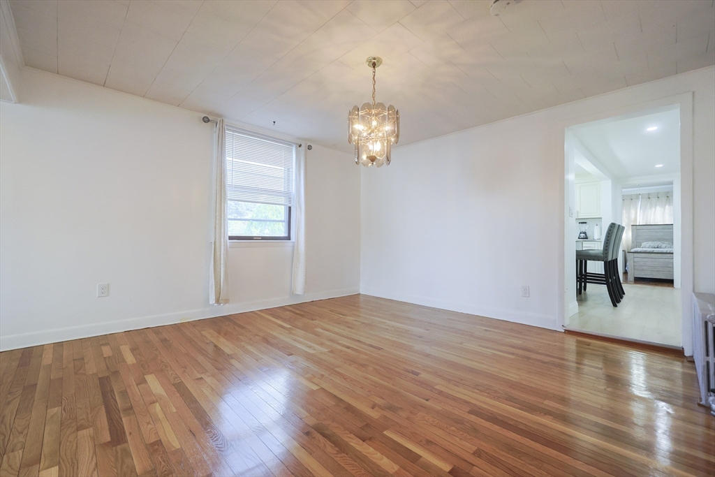 1245 North High Street Fall River, MA 02720 - Photo 18 of 28 a view of livingroom with hardwood floor and kitchen view