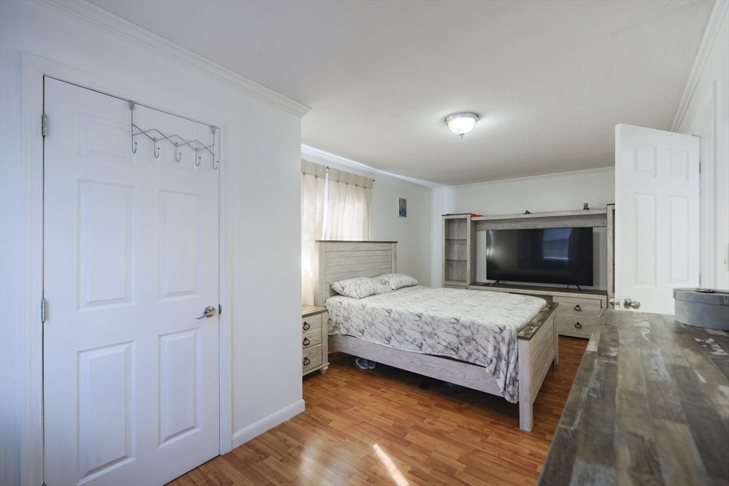1245 North High Street Fall River, MA 02720 - Photo 22 of 28 a bedroom with a bed and a flat screen tv