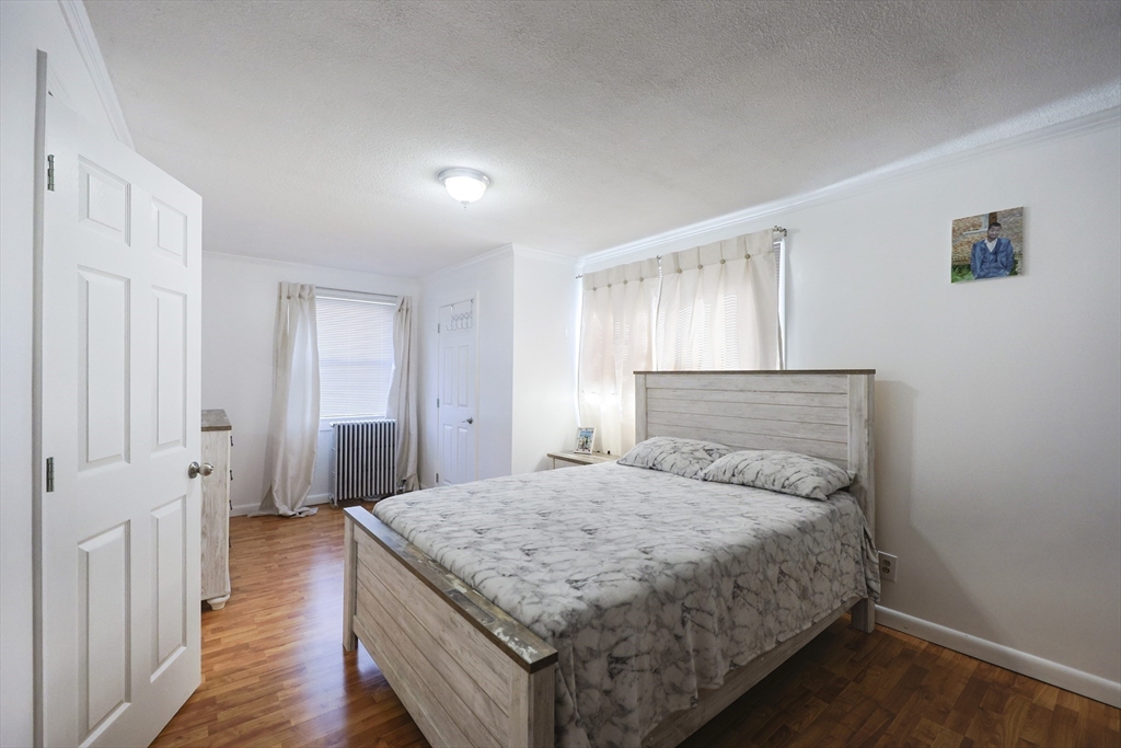 1245 North High Street Fall River, MA 02720 - Photo 24 of 28 a bedroom with a bed and wooden floor