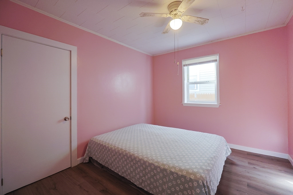 1245 North High Street Fall River, MA 02720 - Photo 25 of 28 a bedroom with a bed chandelier and a window