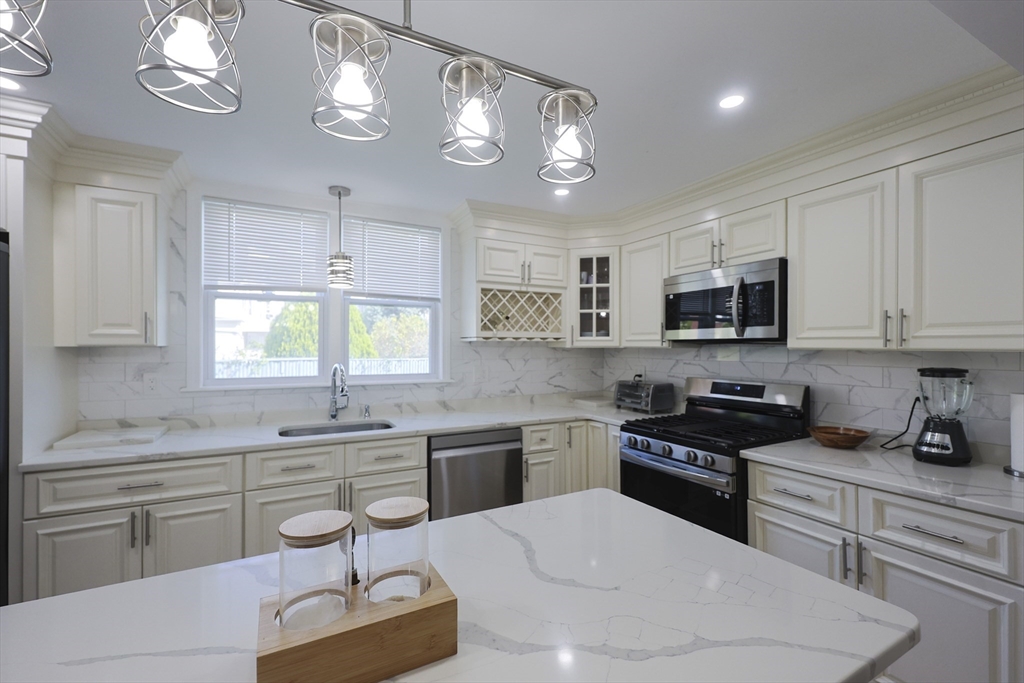 1245 North High Street Fall River, MA 02720 - Photo 6 of 28 a kitchen with stainless steel appliances kitchen island granite countertop a sink and cabinets