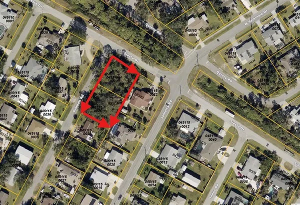 an aerial view of a multi story building with yard