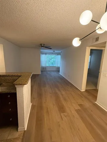 a view of a kitchen from the hallway