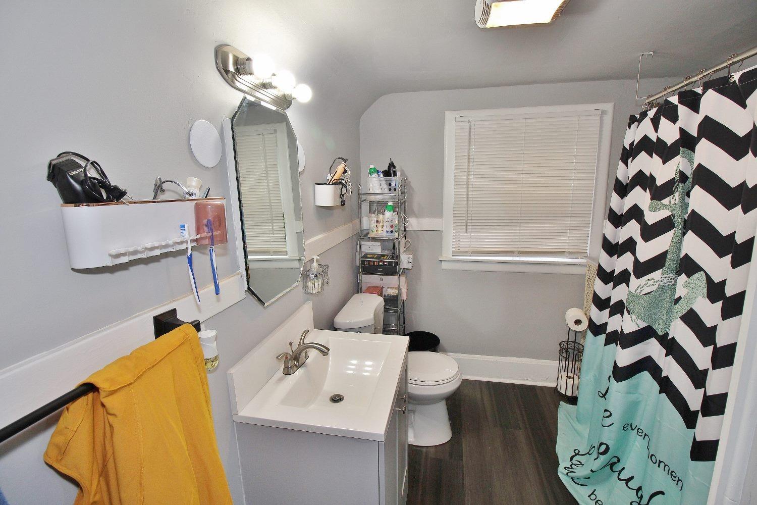 18 Williams Street Hammond, IN 46320 - Photo 8 of 15 a bathroom with a sink a mirror and a toilet