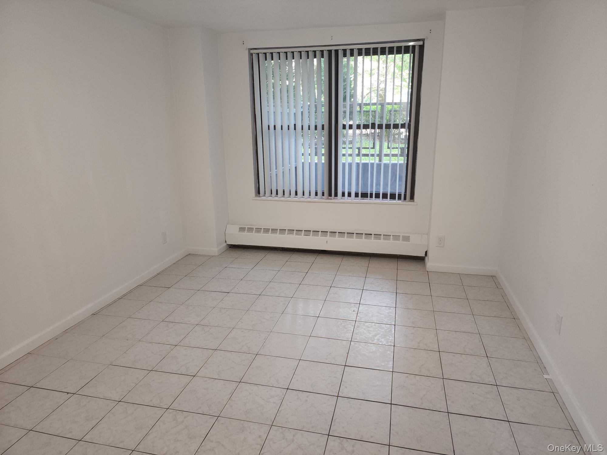 61-35 98th Street, Unit STG Queens, NY 11374 - Photo 9 of 12 an empty room with windows