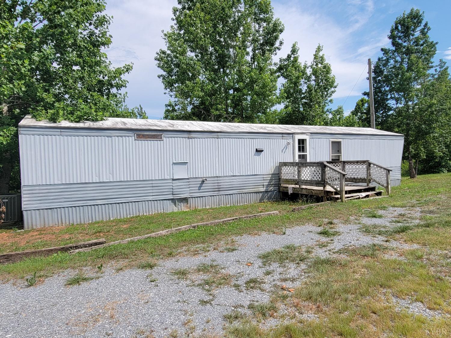 3310 Mountain Road Gretna, VA 24557 - Photo 2 of 15 a view of a backyard with chairs and floor to ceiling window and wooden fence
