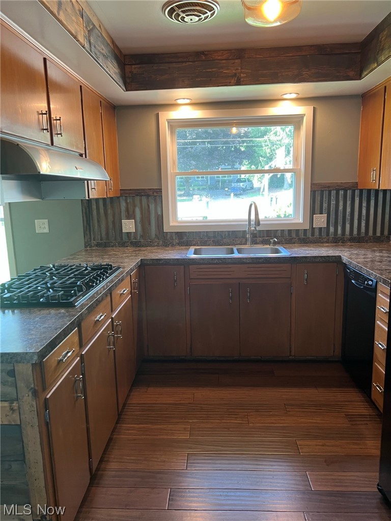 294 Lester Road New Franklin, OH 44319 - Photo 7 of 24 Kitchen with gas cooktop, black dishwasher, wood-type flooring, and backsplash