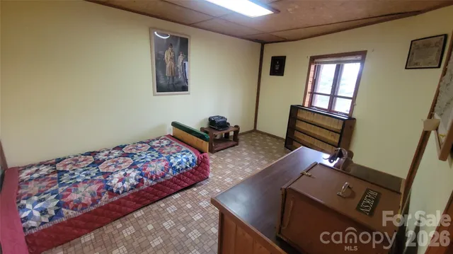 a bed room with a bed and a chair