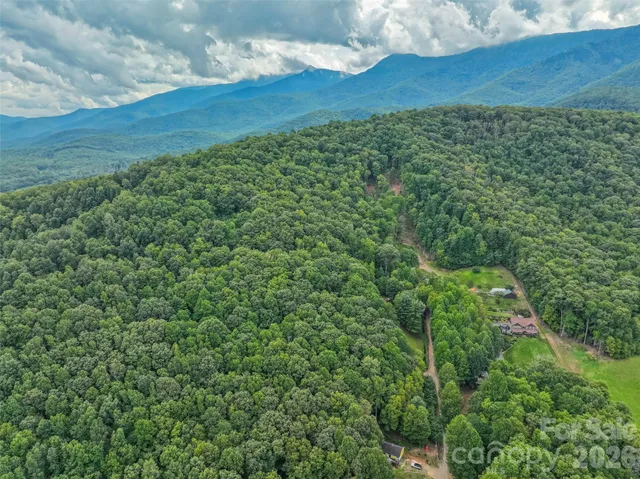 a backyard of a house with a yard and outdoor seating