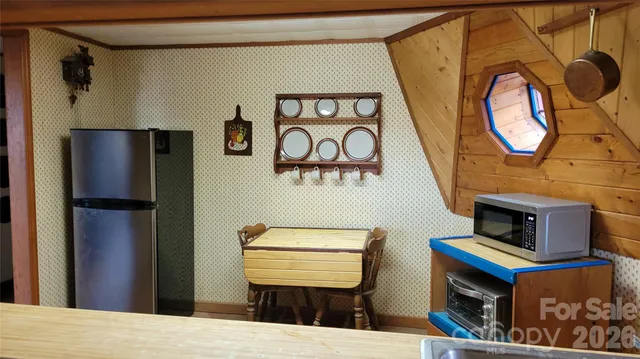 a room with stainless steel appliances kitchen island a stove and a refrigerator