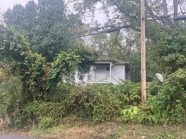 a view of a house with a tree
