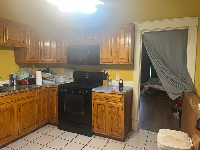 a kitchen with a sink stove and cabinets