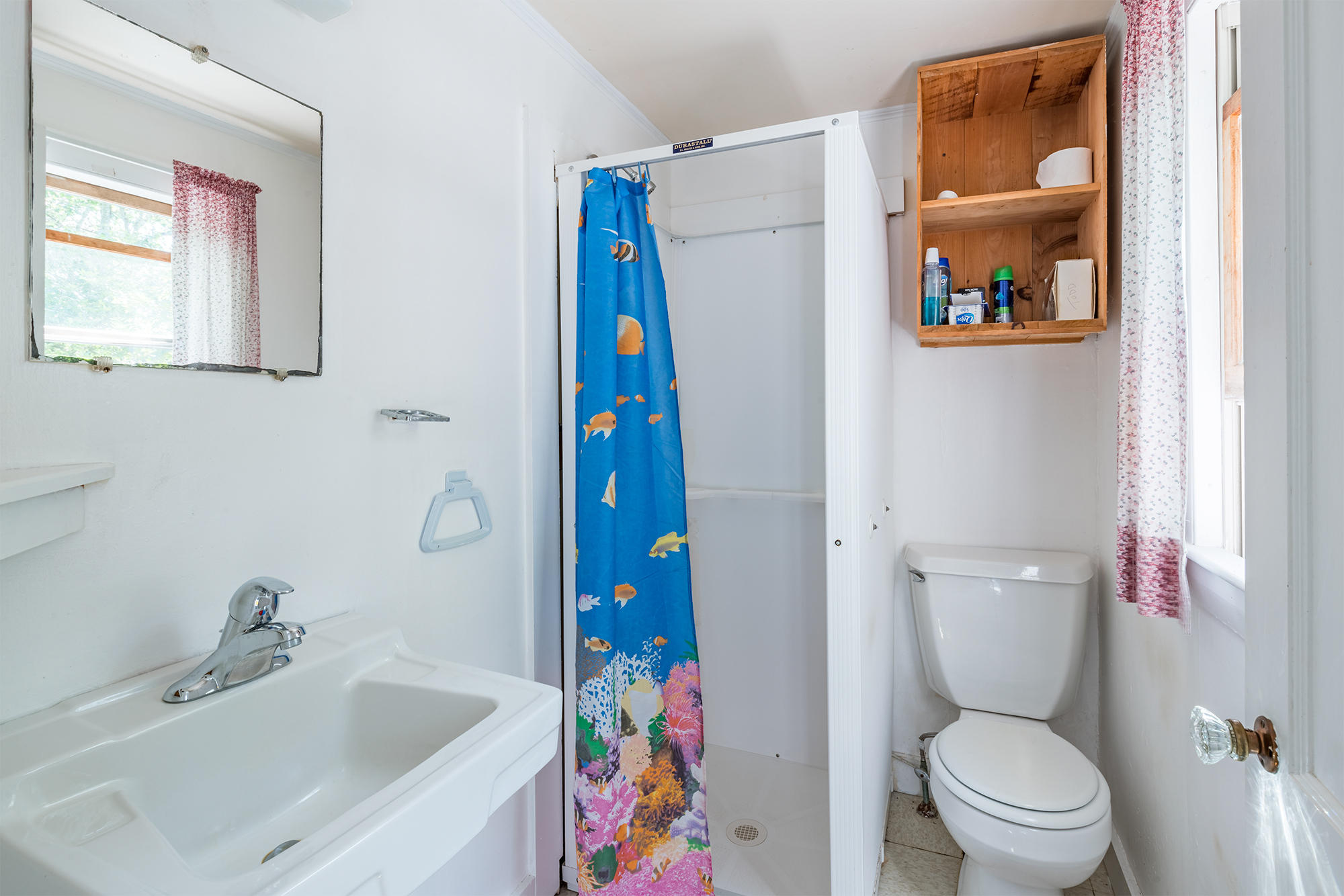 254 Ridgevale Road Chatham, MA 02633 - Photo 8 of 25 a white toilet sitting next to a bathroom sink