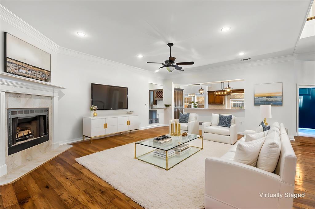 609 Seville Road Denton, TX 76205 - Photo 5 of 39 Spacious Living Room open to entry, kitchen, dining with hardwood floors & gas logs fireplace. Virtually Staged.