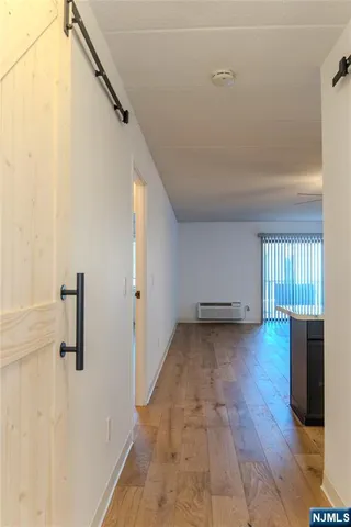 a view of a livingroom with wooden floor and staircase