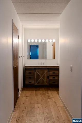 a bathroom with a double vanity sink and a mirror