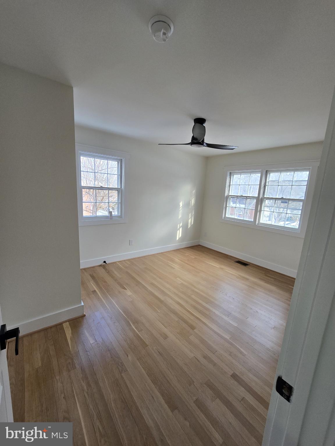 1014 Nora Drive Silver Spring, MD 20904 - Photo 16 of 23 an empty room with wooden floor and windows